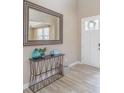 Bright entryway with hardwood floors, decorative table, and ample natural light at 404 Dusk Ct, Erie, CO 80516