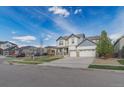 Attractive two-story home featuring a three-car garage and well-manicured front yard at 404 Dusk Ct, Erie, CO 80516
