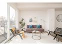 Living area with sliding glass door to balcony and modern decor at 5653 W 10Th Ave, Lakewood, CO 80214