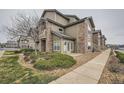 Attractive multi-story home with stone accents, well-maintained landscaping, and a welcoming entrance in a peaceful neighborhood at 3205 S Walden Ct # H, Aurora, CO 80013