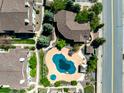 Aerial view of a community pool, landscaped grounds, and surrounding townhomes at 8705 W Berry Ave # 204, Littleton, CO 80123