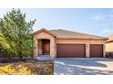 Charming home with a three car garage, stone accents, a tiled roof, and lovely curb appeal at 7700 W Grand Ave, Littleton, CO 80123