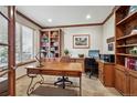 Well-lit office with wood trim, built in shelves, and a large window at 7700 W Grand Ave, Littleton, CO 80123