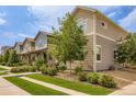 Street view of well-manicured home exteriors featuring landscaped front yards and concrete sidewalks at 1137 Hummingbird Cir, Longmont, CO 80501