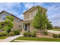 Attractive two-story home with low maintenance front yard landscaping with a stone base and walkway at 1137 Hummingbird Cir, Longmont, CO 80501