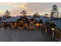 Picturesque single-Gathering home with meticulously landscaped grounds, dark metal roof, and inviting curb appeal at 4446 Songbird Ln, Evergreen, CO 80439