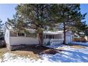 Gray house with white deck and snowy front yard at 287 Johnson Dr, Castle Rock, CO 80104