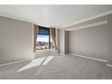 Inviting bedroom with a neutral color scheme, large window with city views, and plush carpeting at 8100 E Union Ave # 1603, Denver, CO 80237