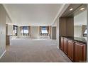 Open living space with city views framed by large windows and modern gray walls with cream colored trim at 8100 E Union Ave # 1603, Denver, CO 80237