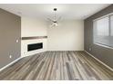 Bright and open living room with wood floors and a fireplace, ready for you to add your personal touches at 228 N Edge Cliff St, Castle Rock, CO 80104