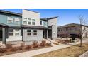 Contemporary townhome showcasing multi-tone exterior, complementing landscaping and an inviting entrance at 16251 E 47Th Pl, Denver, CO 80239
