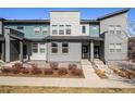 Modern townhome featuring multi-tone exterior and inviting front entrance with walkway, complimented by drought tolerant landscaping at 16251 E 47Th Pl, Denver, CO 80239