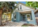 Attractive home with a beautifully landscaped front yard and welcoming front porch at 269 Delaware St, Denver, CO 80223