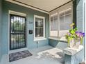 Welcoming porch with painted brick, flower pot, and stylish black door at 269 Delaware St, Denver, CO 80223