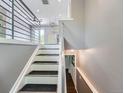 Bright stairway with modern railing that leads to the main floor at 12991 E Idaho Dr, Aurora, CO 80012