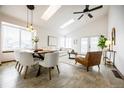 Open-concept living and dining area, highlighted by modern lighting and vaulted ceilings at 1940 W 101St Ct, Thornton, CO 80260