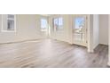 Bright living room featuring light gray vinyl plank flooring and an open floor plan at 1242 S Algonquian, Aurora, CO 80018