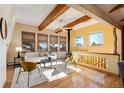 Bright living room with wood beams, wood burning stove and large windows at 12041 Twilight St, Longmont, CO 80503