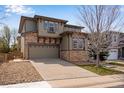 Beautiful two-story home featuring stone accents, a well-kept lawn, and an attached two-car garage at 5503 Fullerton Cir, Highlands Ranch, CO 80130