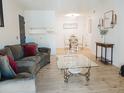 Open concept living room and dining area featuring modern decor and wood flooring at 14413 E Jewell Ave # 201, Aurora, CO 80012