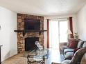 Comfortable living room with stone fireplace and large windows at 14413 E Jewell Ave # 201, Aurora, CO 80012