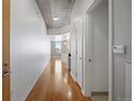 Hallway with concrete ceilings and hardwood flooring at 891 14Th St # 2904, Denver, CO 80202