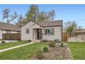 Quaint single-Gathering home with a green lawn and garden beds, showcasing curb appeal at 4425 S Lincoln St, Englewood, CO 80113
