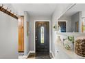 Inviting home entryway with decorative front door, a stylish console table, and a contemporary mirror at 1818 South Union Ct, Lakewood, CO 80228