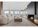 Elegant living room filled with natural light, featuring a cozy fireplace and scenic views at 974 N Faver Dr, Castle Rock, CO 80109
