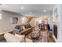 Open-concept living room showcasing hardwood floors, fireplace, and seamless flow to dining area at 3346 N Josephine St, Denver, CO 80205