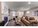 Bright living room features a cozy fireplace, neutral walls, and large windows for natural light at 3346 N Josephine St, Denver, CO 80205