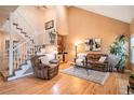 Inviting living room with vaulted ceilings, a cozy fireplace, and large windows offering natural light at 9875 Greensview Cir, Lone Tree, CO 80124
