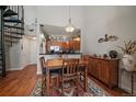 Dining area featuring a wooden table, seating for four, and an adjacent kitchen with stainless appliances at 9019 E Panorama Cir # D502, Englewood, CO 80112