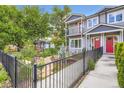 Charming home featuring a landscaped front yard with a black metal fence and walkway at 4728 S Acoma St, Englewood, CO 80110