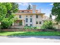 Elegant home with a red tile roof, classic architecture, and a well-maintained front lawn and brick retaining wall at 199 Lafayette St, Denver, CO 80218