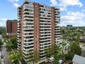 Tall building with balconies offers urban living with city views, nestled among green trees on a sunny day at 130 N Pearl St # 1103, Denver, CO 80203