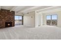 Bright living room with fireplace, carpet and sliding glass doors that open to a private balcony at 130 N Pearl St # 1103, Denver, CO 80203