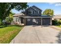 Charming two-story home with a three-car garage, well-manicured lawn, and solar panels at 2089 Meadow Sweet Ln, Erie, CO 80516