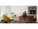 Bright living room featuring hardwood floors, a cozy fireplace, and modern decor at 221 Adams St, Denver, CO 80206