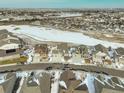 Wide aerial view of a snow-covered residential community and neighborhood at 15842 Willow St, Brighton, CO 80602