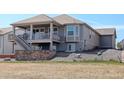 Exterior showcases a spacious balcony, a stone patio, and a well-maintained backyard, perfect for outdoor enjoyment at 15842 Willow St, Thornton, CO 80602