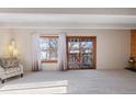 Bright living room with large windows and sliding doors to the outdoor deck at 2525 S Dayton Way # 1514, Denver, CO 80231
