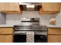 Close-up view of a stainless steel oven in kitchen with tile backsplash at 2525 S Dayton Way # 1514, Denver, CO 80231