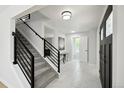 Bright and airy foyer with modern staircase, stylish tile flooring, and a welcoming entrance at 8701 E Briarwood Blvd, Centennial, CO 80112