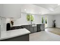 Well-lit kitchen with gray cabinetry, stainless steel appliances, and an open layout perfect for cooking at 8701 E Briarwood Blvd, Centennial, CO 80112