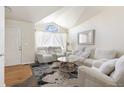 Spacious living room with white couches and a view into the kitchen at 5593 S Himalaya Way, Centennial, CO 80015