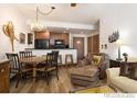 Living room features rustic decor with kitchen in background, wood flooring and comfortable seating at 34 Highfield Trl # 212, Breckenridge, CO 80424