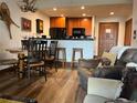 Comfortable living room with wooden floors, kitchen bar, and rustic decor at 34 Highfield Trl # 212, Breckenridge, CO 80424
