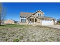 Beautiful two-story home with an attached two-car garage, complemented by well-maintained landscaping and a barn at 16275 Electra St, Brighton, CO 80603