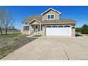 Inviting two-story home featuring an attached two-car garage, well-maintained landscaping, and great curb appeal at 16275 Electra St, Brighton, CO 80603